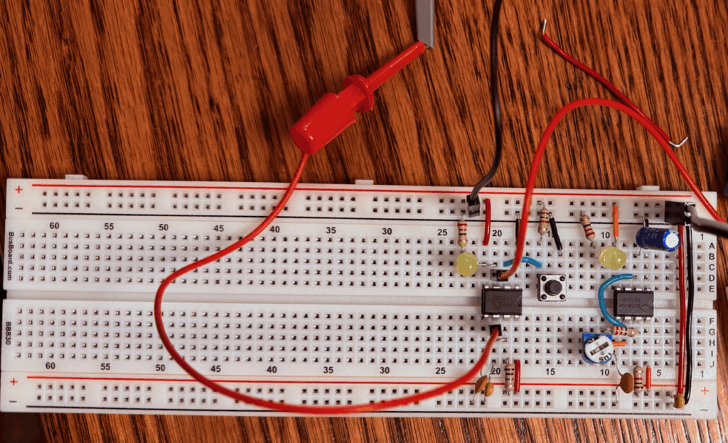 My implementation of the clock module with only the astable and monostable timers assembled. Leads to pin 3 and 6 are visible going to oscilloscope probes.