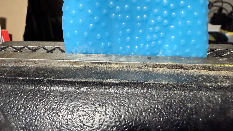 The rubber chicken clamped in a vise to aid in getting a straight cut